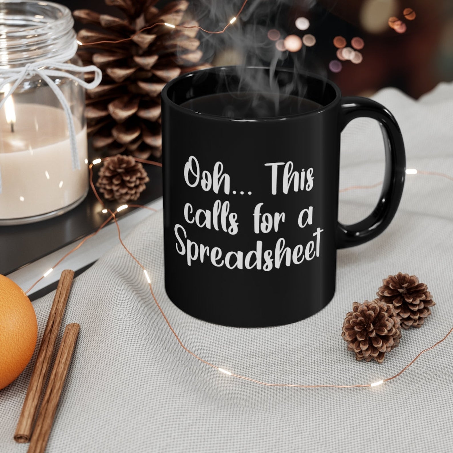 black mug filled with coffee with white text that reads 