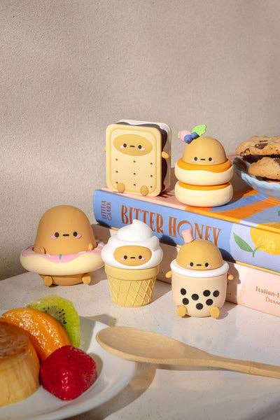 five figurines of a potato dressed as a donut, soft serve ice cream cone, boba, an ice cream sandwich, and pancakes