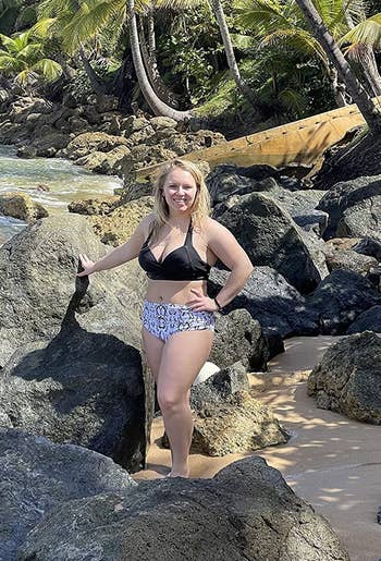 reviewer wearing the bathing suit with a black top and printed bottoms