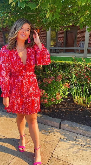 reviewer in the red short dress