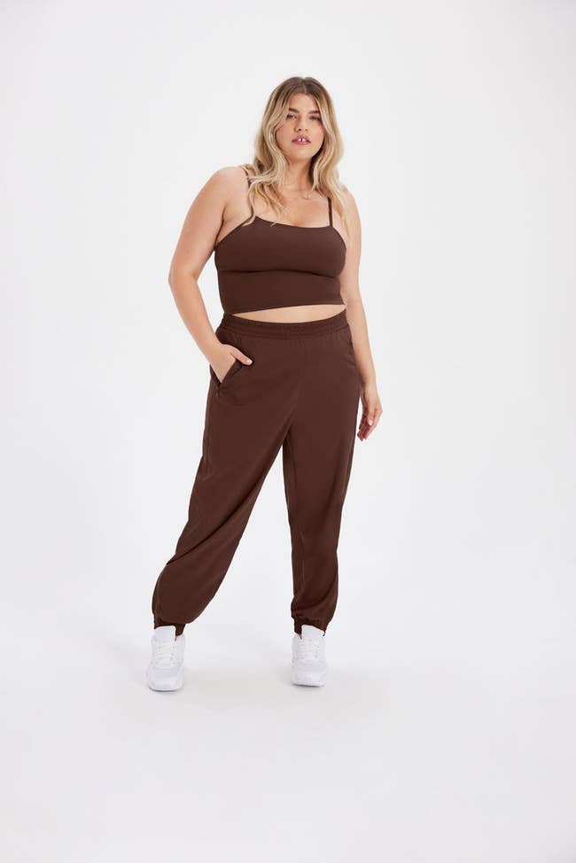 model wearing the brown track pant with a matching tank top