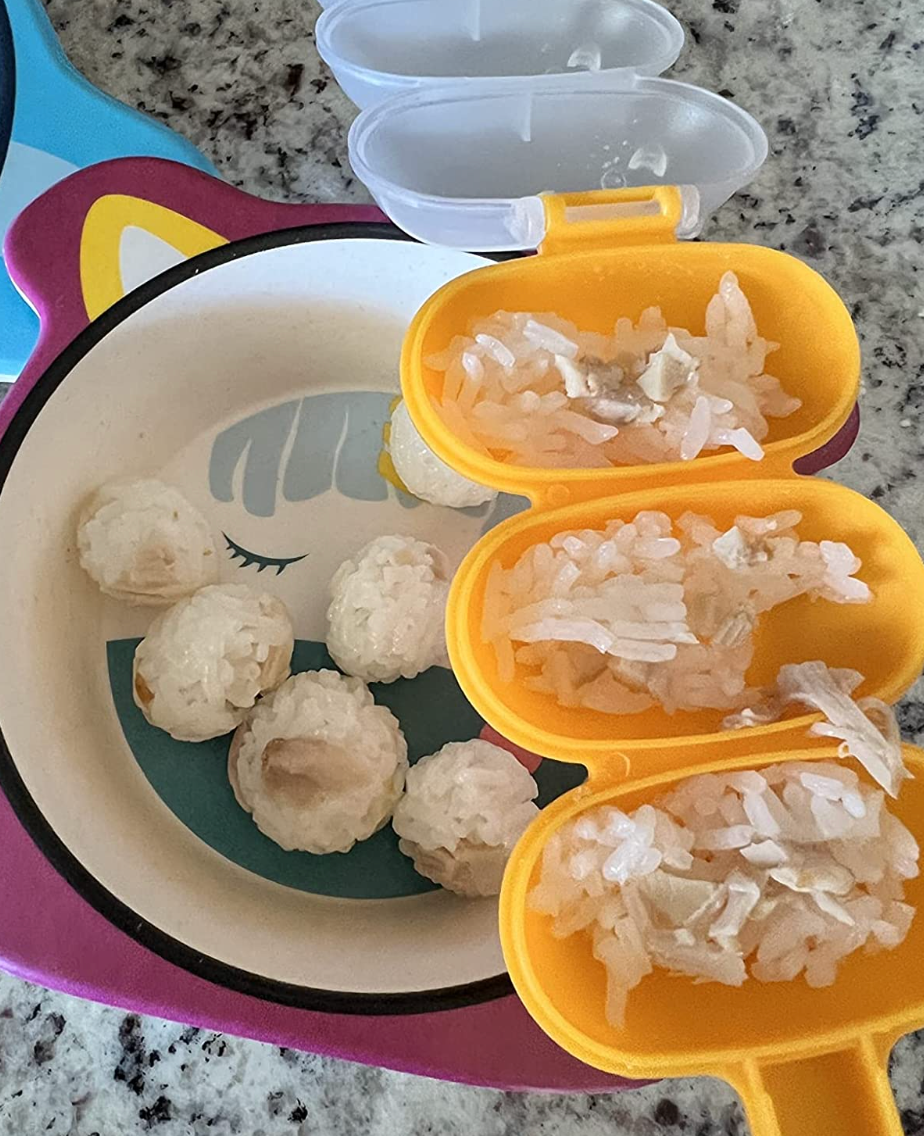Rice balls next to a small yellow handheld shaker with three compartments for loose rice 
