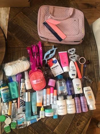 reviewer photo of several toiletries next to the bag