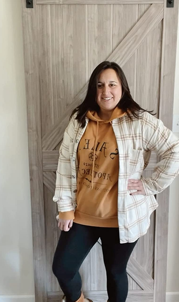 reviewer photo wearing the beige plaid shacket over a hoodie