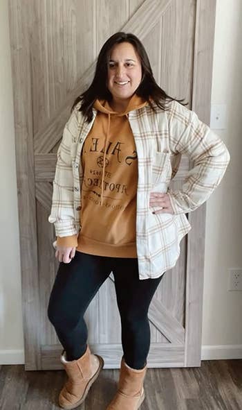 reviewer photo wearing the beige plaid shacket over a hoodie 