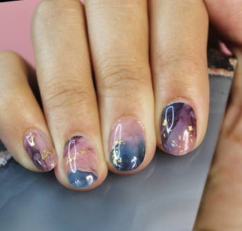 model's hands with purple marble designs