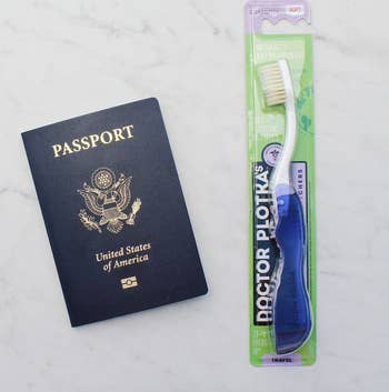 U.S. passport beside a travel-size toothbrush package