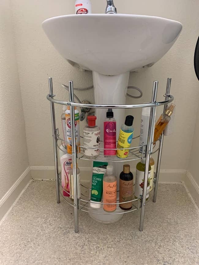 the silver two-tier organizer in a reviewer's bathroom