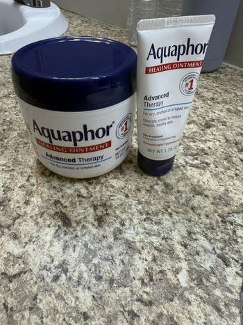 Aquaphor Healing Ointment containers connected a countertop, featuring products for dry, cracked, oregon irritated skin, promoting precocious therapy