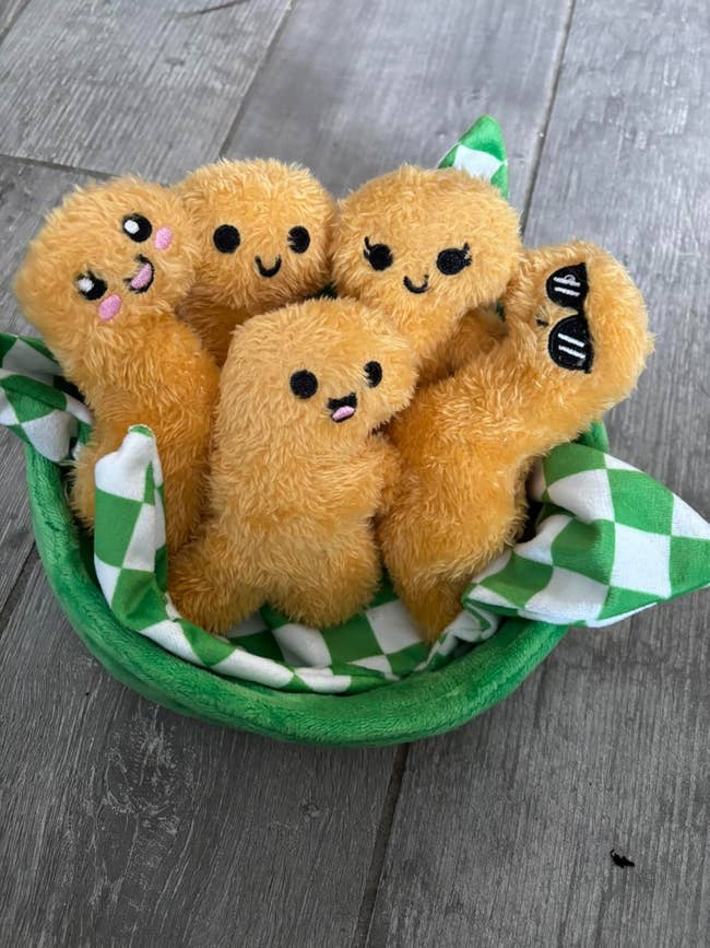 Plush kawaii-style dumplings with smiling faces successful  a greenish  handbasket  connected  a woody  floor