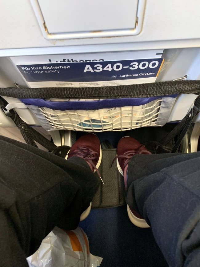 View of a person's legs and feet successful an airplane ft hammock