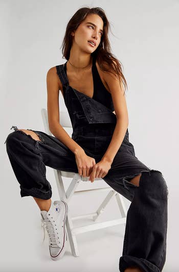 the pair of denim overalls in Mineral Black Accidental Rip