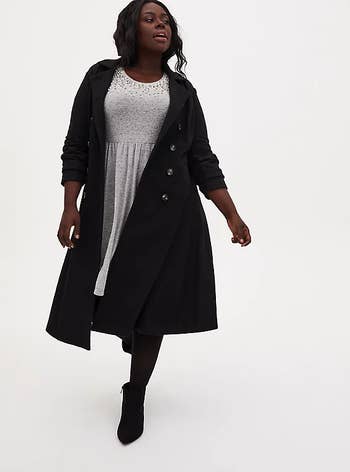 A model wearing the flare coat unbuttoned