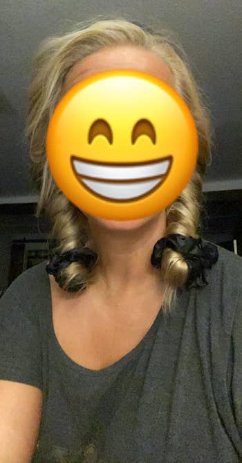 Person with smiley look   emoji and curling accessories successful  hair, wearing a casual top