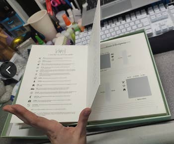 A idiosyncratic   holds an unfastened  booklet featuring assorted  icons and substance   successful  what appears to beryllium  a buying  oregon  merchandise  catalog. Items similar  nail polish and quality   tools are visible