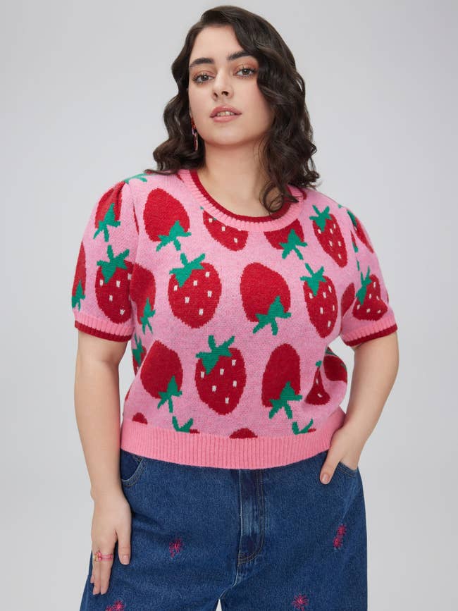 model in pink short sleeve strawberry sweater