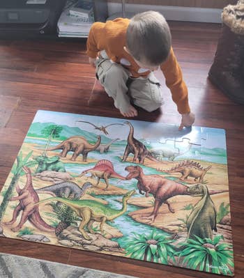 another reviewer's child finishing a dinosaur puzzle