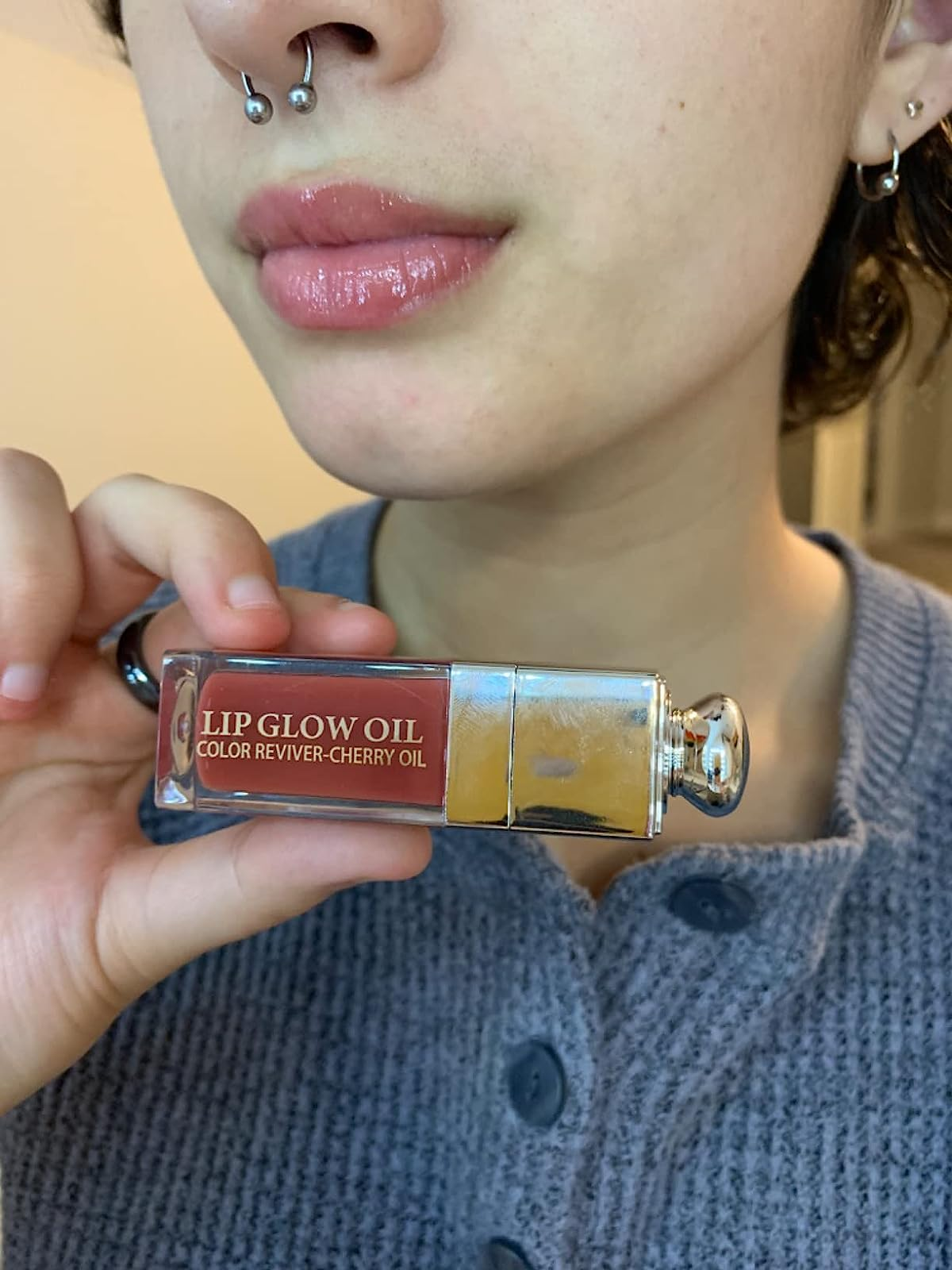 reviewer holding up lip oil