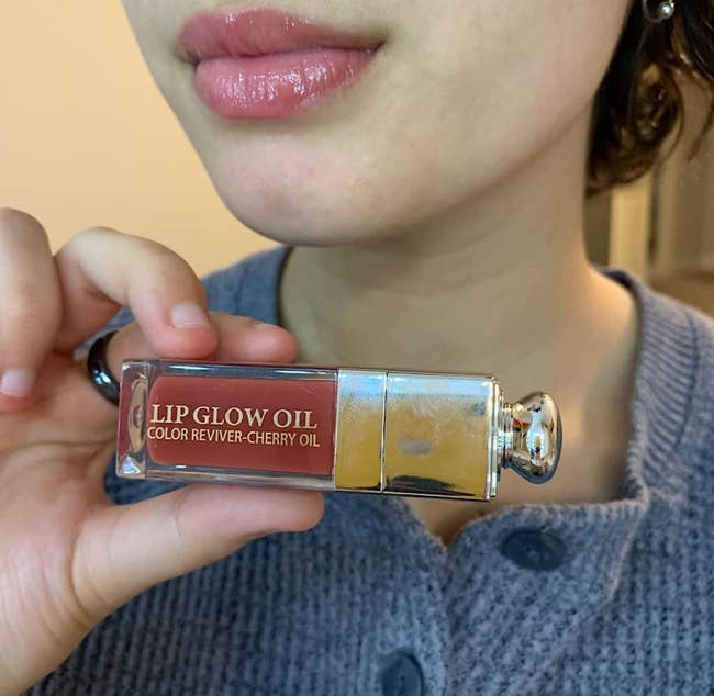 reviewer holding up lip oil