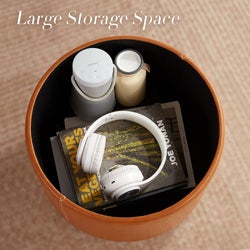 the storage space inside filled with books, headphone, a speaker and more