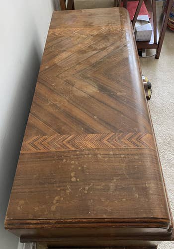 reviewer photo of wooden furniture looking dirty and scratched up