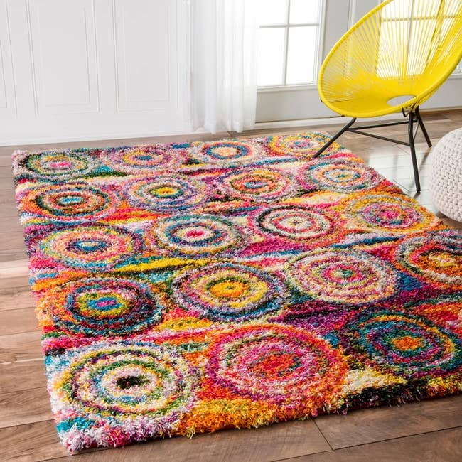 A multicolored circle patterned rug in the shape of a rectangle 