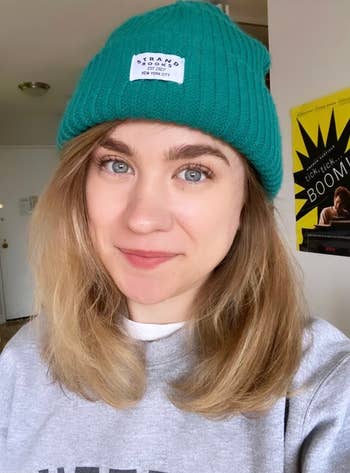 buzzfeed editor wearing a teal beanie from the strand