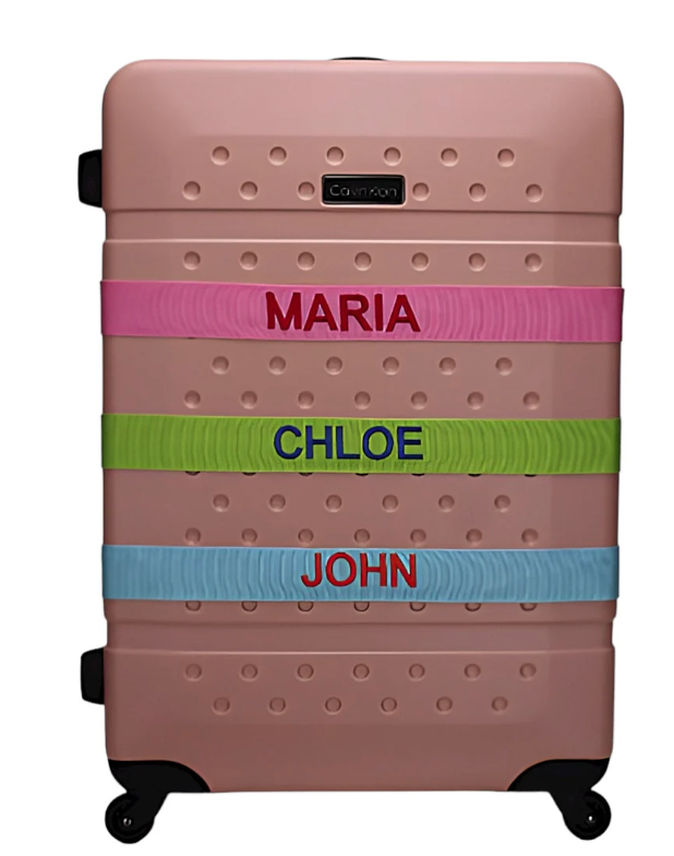 Luggage with three embroidered straps with the names Maria, Chloe, and John