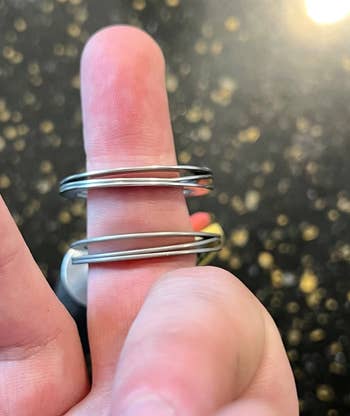 reviewer photo of the freekey on their finger showing the three rings