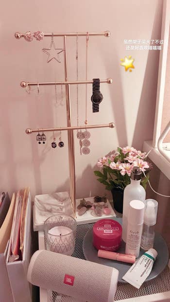reviewer photo of rose gold jewelry stand on a desk