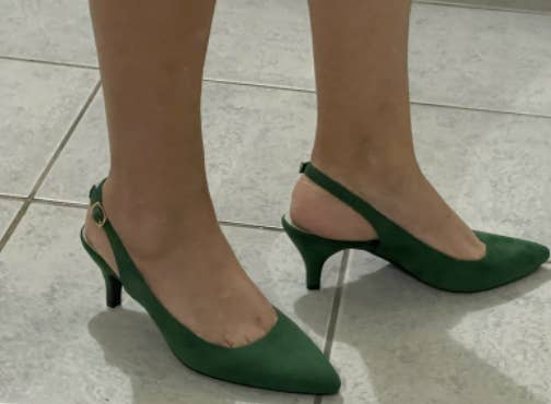 Reviewer wearing green slingback heels