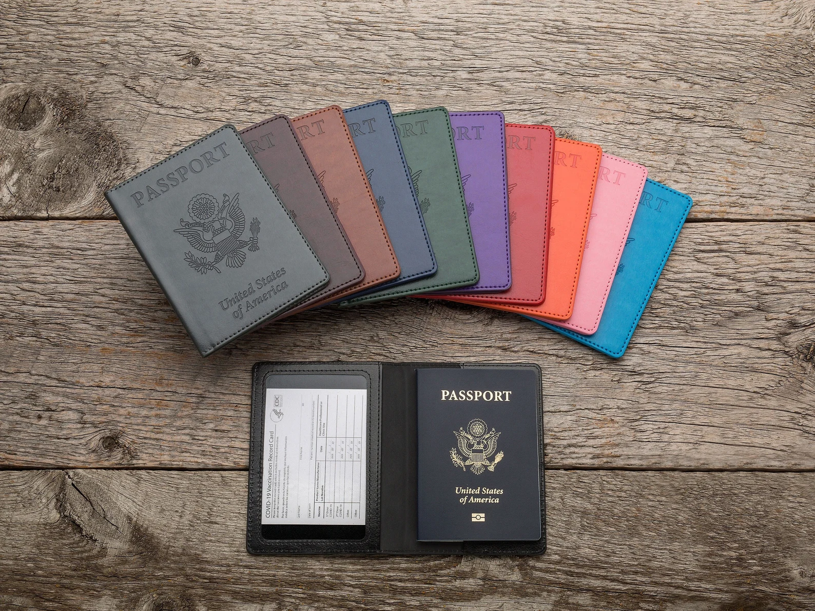 several different colored vaccine passports on a table