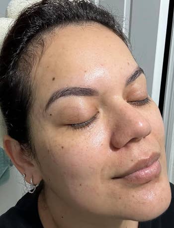 a reviewer with moisturizer on face
