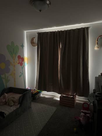 Children's country with acheronian curtains, a tiny furniture with toys nearby, and playful partition creation featuring flowers and a moon