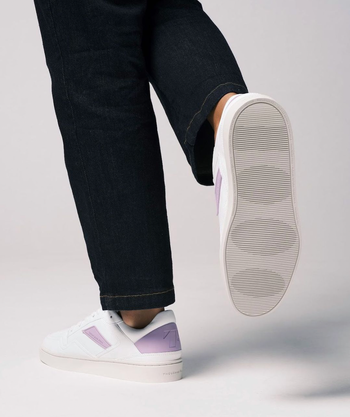 a model wearing the sneakers in psychic wave