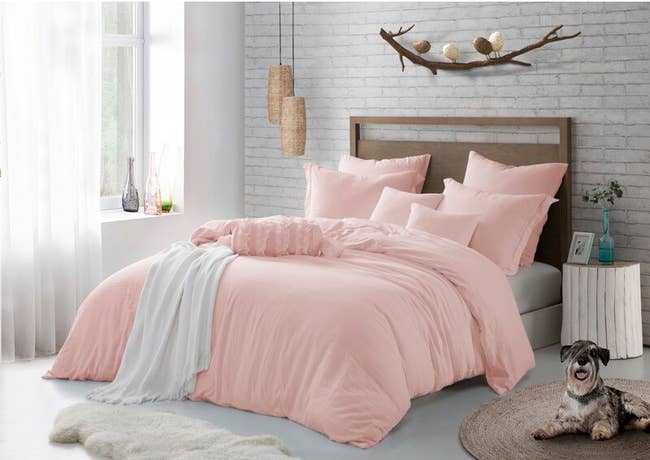 A pink bedroom set in a room