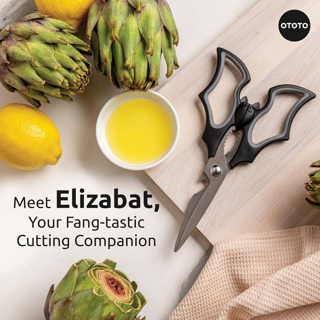 Advertisement for Elizabat scissors, styled like a bat, with artichokes, a lemon, and olive oil