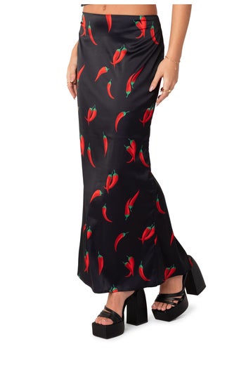 front view of a model wearing the black and red chili pepper printed skirt