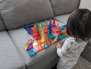 a reviewer's kid playing with the colorful tiles