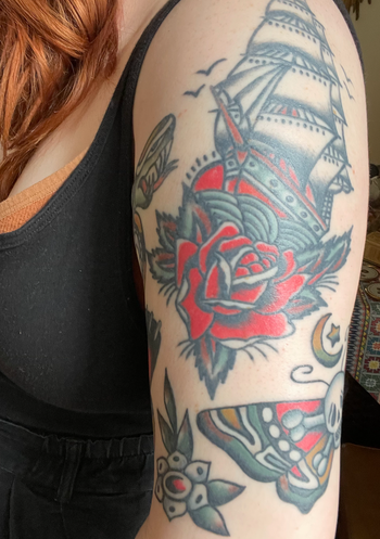 my arm in colored tattoos highlighted with the product 