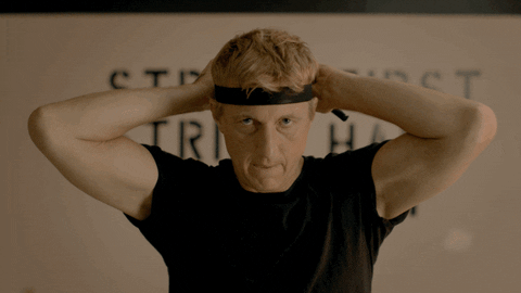 Johnny from Cobra Kai tying in a head band