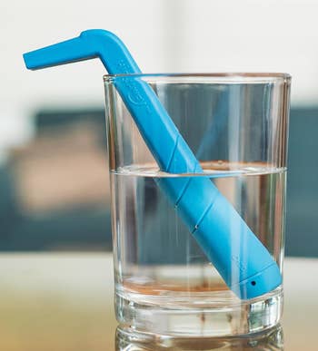 the blue straw in a glass of water 