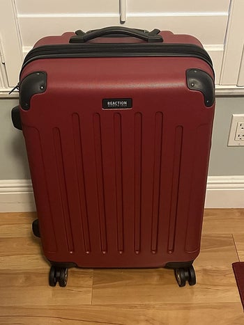 reviewer photo of red hard-side suitcase