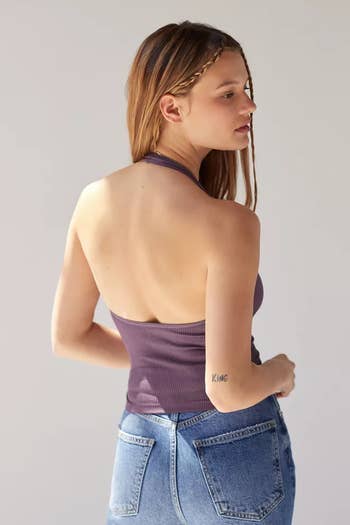 back of a model wearing a purple halter bra top