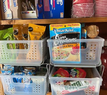 another reviewer showing the slide-out storage basket full of snacks