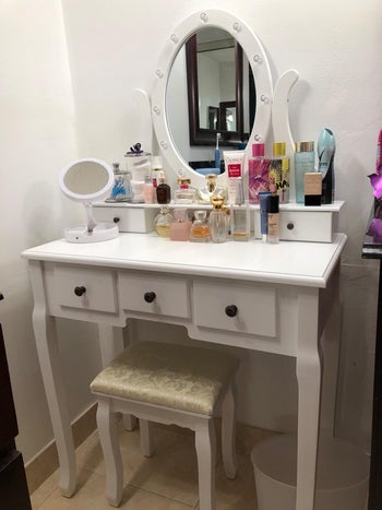 reviewer photo of makeup and perfume on vanity