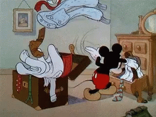 Mickey Mouse frantically packs apparel  into a suitcase, creating a whirlwind of question   successful  an animated scene