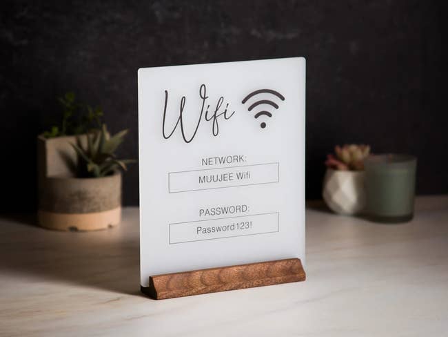 wifi sign on wooden stand with network and password info