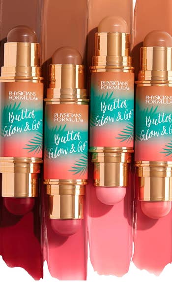 Four tubes of Physician's Formula Butter Glow & Go. Each conduit  has a tropical plan  with golden  accents, showcasing antithetic  constitution  instrumentality   shades