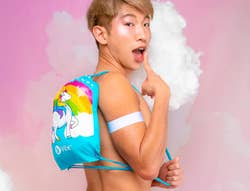 Model wearing light blue unicorn drawstring backpack